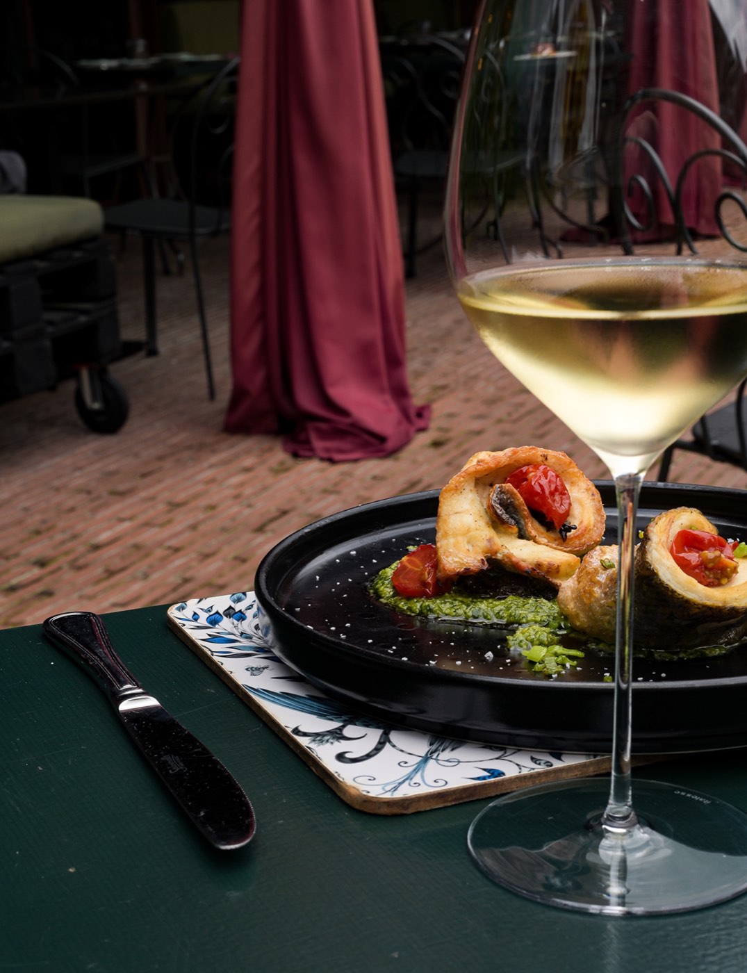 Plated dish and white wine at Brut Merate