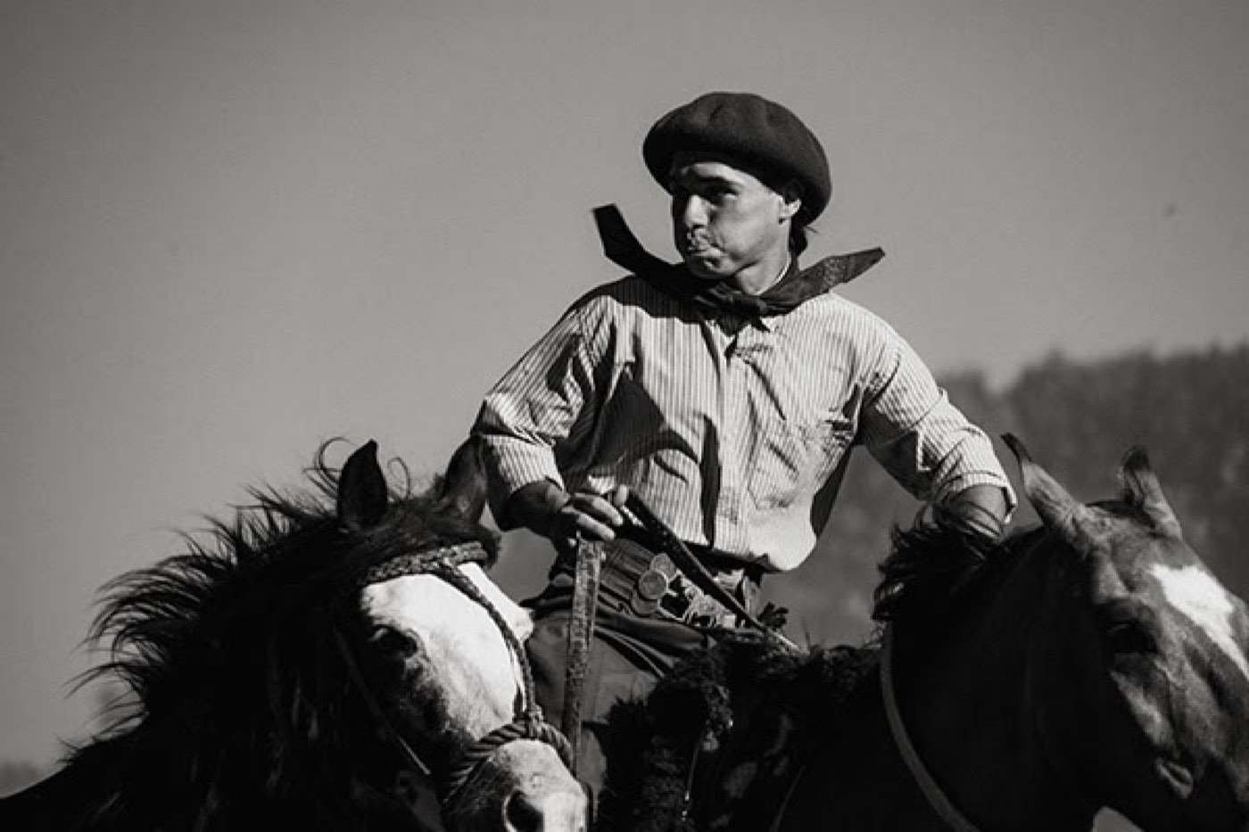 Black-and-white portrait of a gaucho on horseback