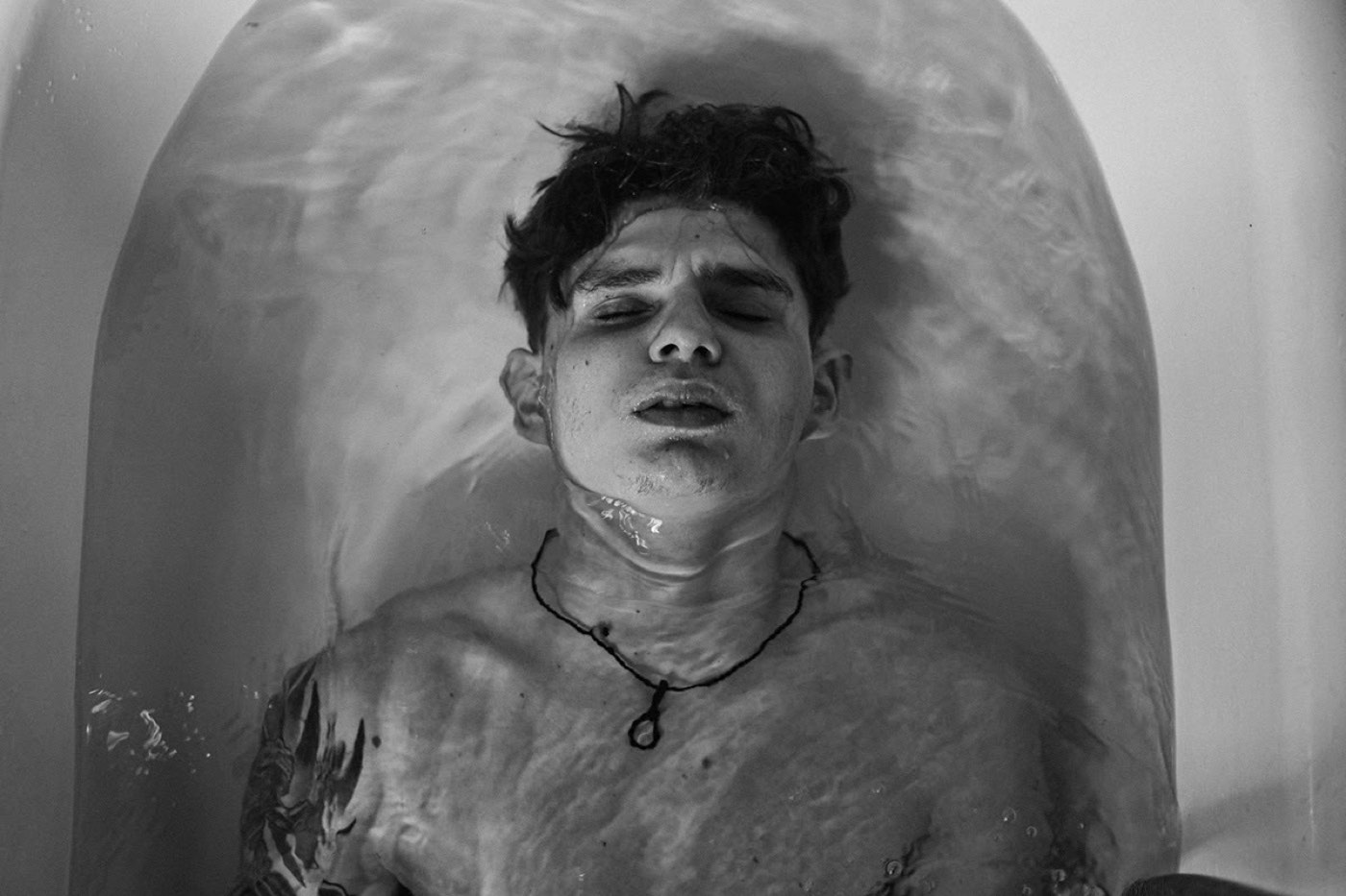 Black-and-white portrait in a bathtub