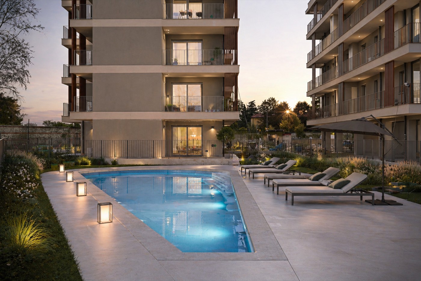 Residential buildings and swimming pool photographed at dusk